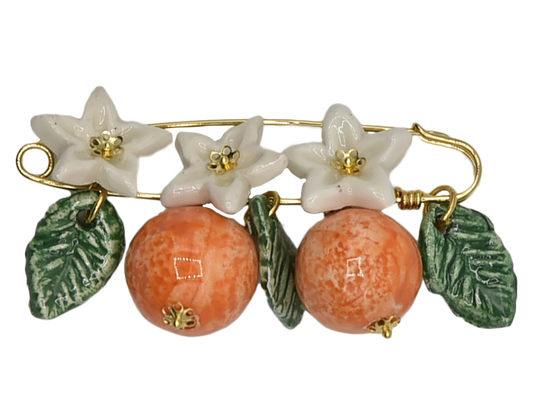 Golden brooch with oranges, flowers and hanging leaves