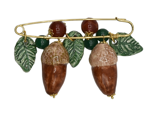 Golden brooch with acorns and hanging leaves in ceramic and semiprecious stone beads
