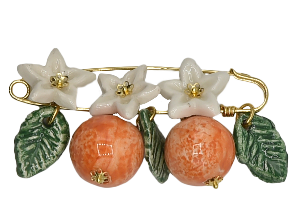 Golden brooch with oranges, flowers and hanging leaves  